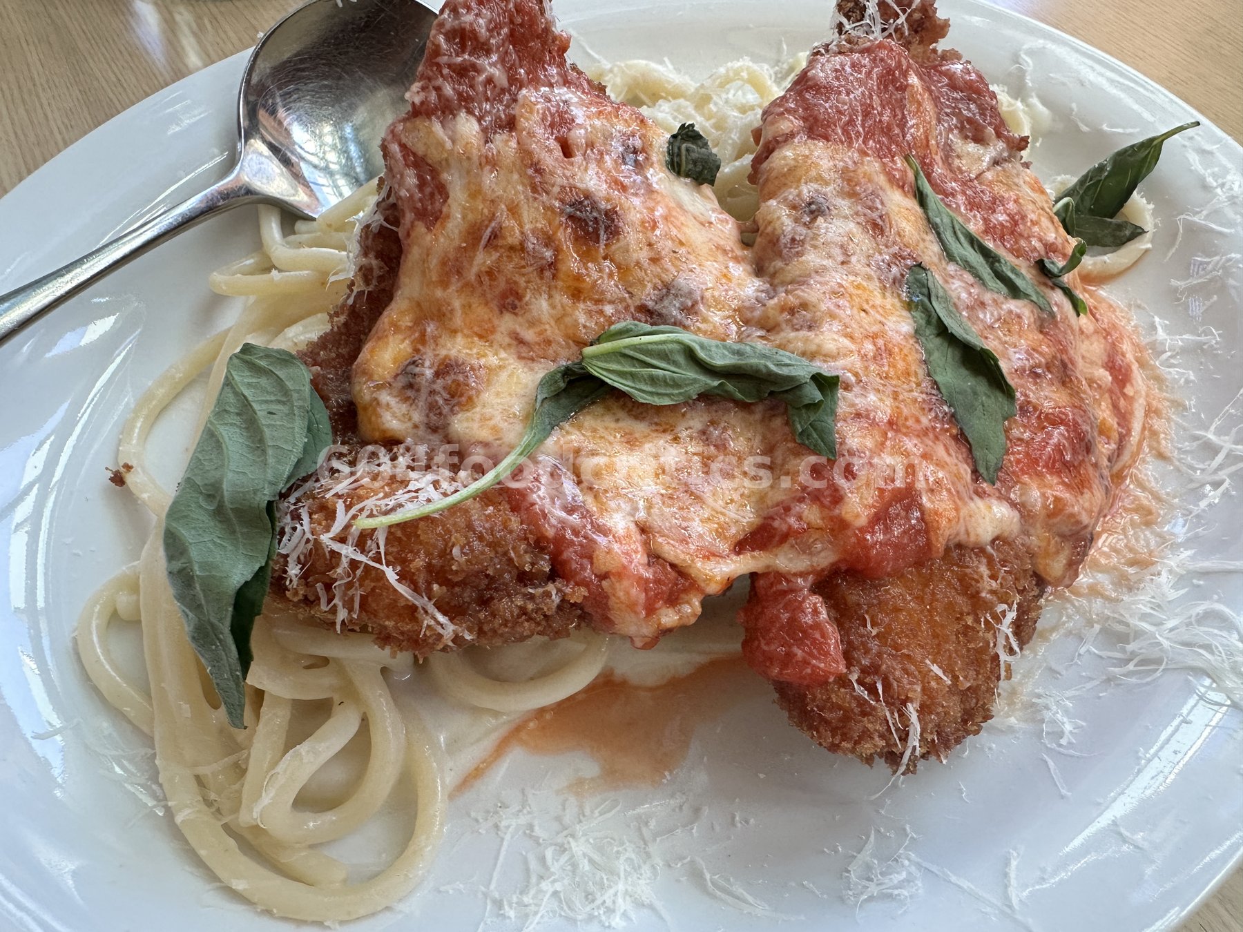 Chicken Parmigiana over spaghetti