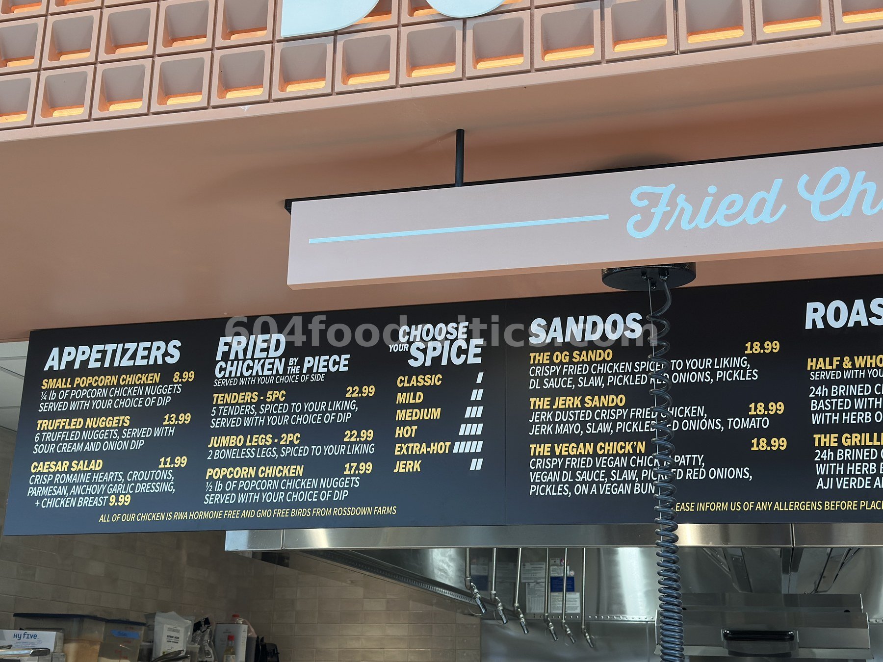 DownLow Chicken menu board at Time Out Market Oakridge: appetizers, fried chicken by the piece, spice levels and sandos