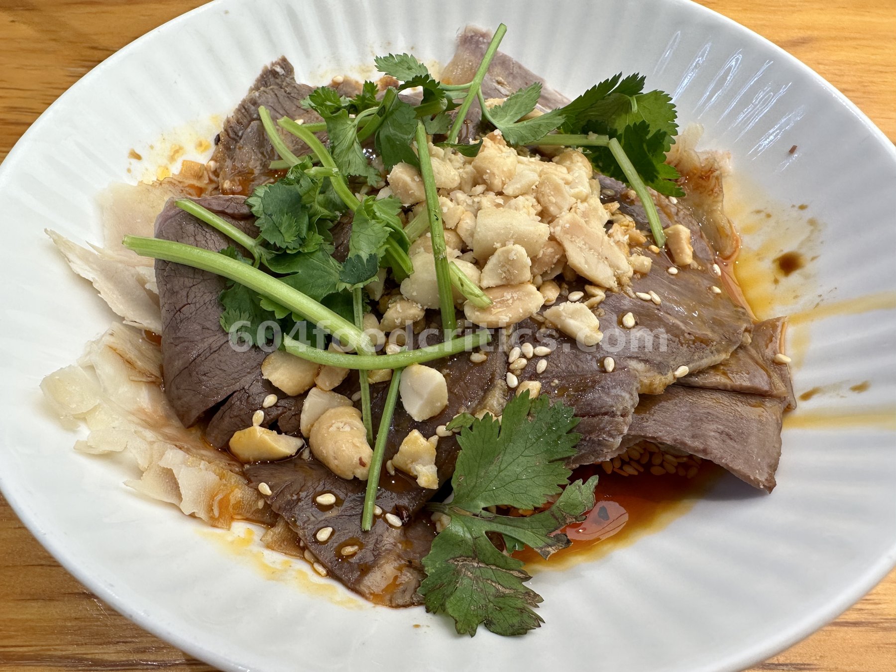 Cold sliced beef in chili oil with peanuts and cilantro at Myth Szechuan