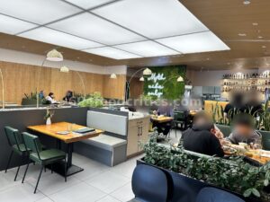 Dining room at Myth Szechuan in Richmond with arc floor lamps and green booths