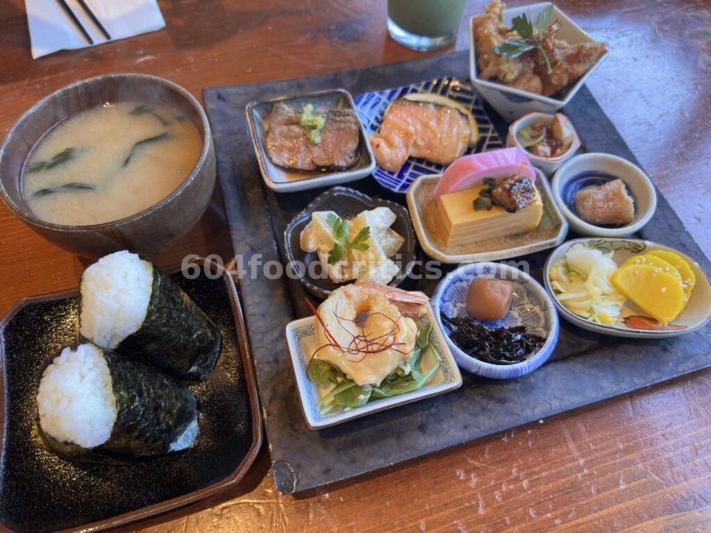 Takenaka Onigiri Obanzai set with two onigiri, miso soup and a tray of eleven small Japanese dishes