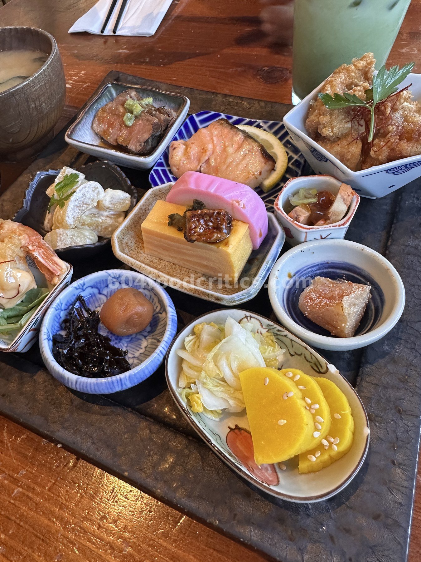 Tamagoyaki topped with glazed eel next to pink kamaboko, seared mentaiko and pickled daikon at Takenaka