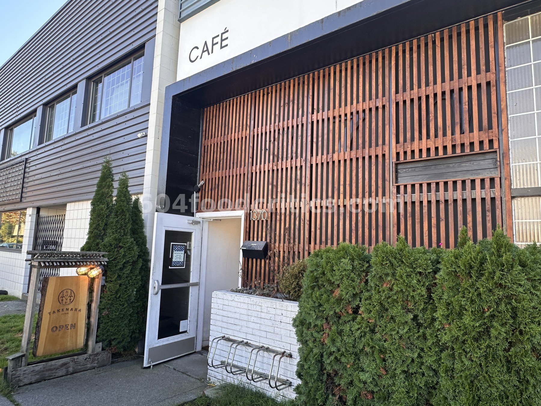 Takenaka Onigiri Cafe entrance with wood slat facade and bamboo-logo sign on East Georgia Street