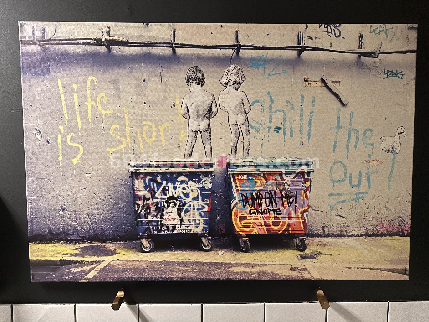 Canvas print of graffiti dumpsters with stencil children and the words "life is short, chill the duck out"